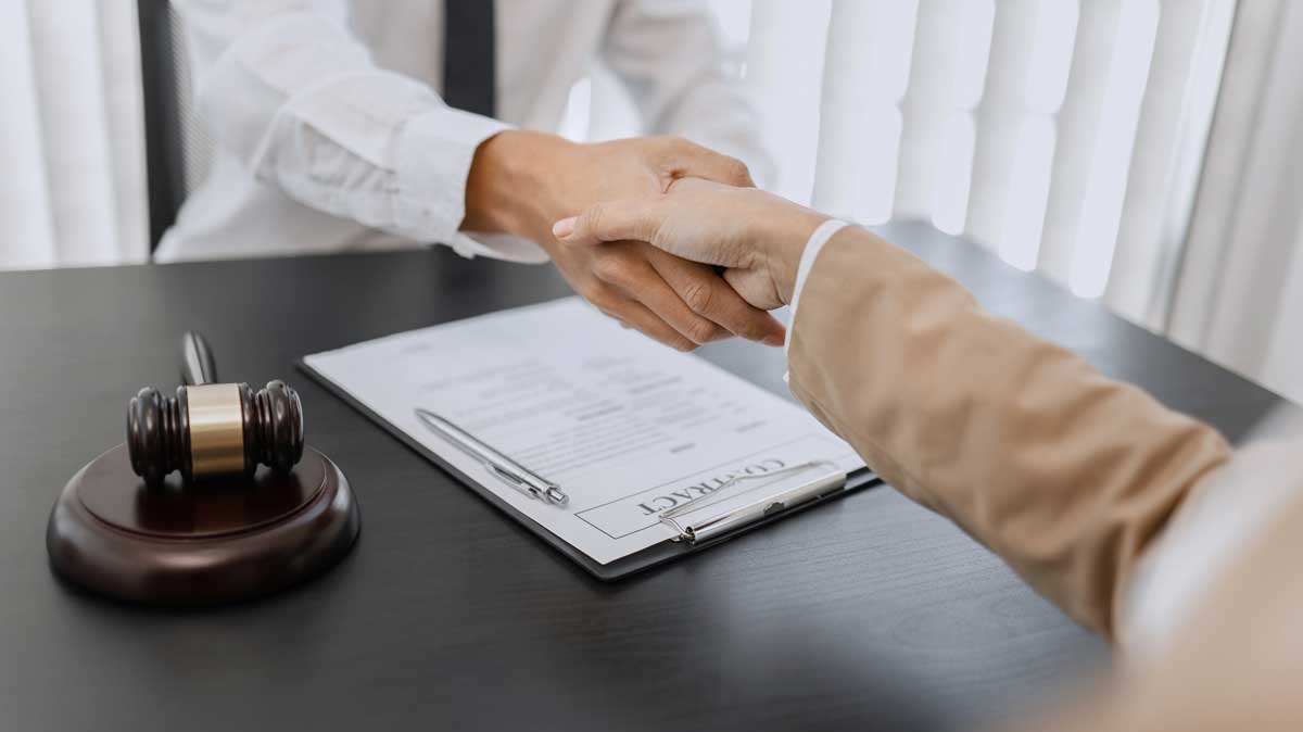 Lawyer shaking hands for blog post - Do I need a personal injury lawyer