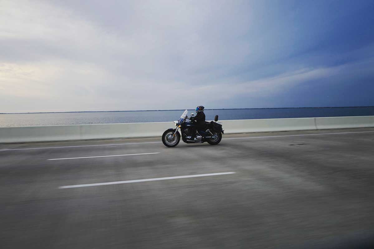 Motorcycle traveling across bridge for blog talking about motorcycle accidents
