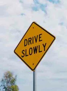 Safe driving tips include following signs such as this drive slowly warning